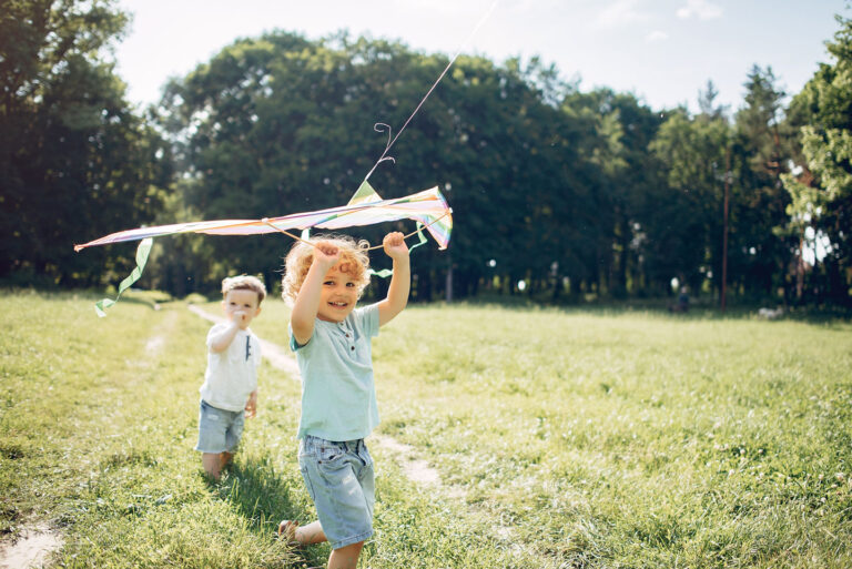cute little child summer field with kitecrop 768x513
